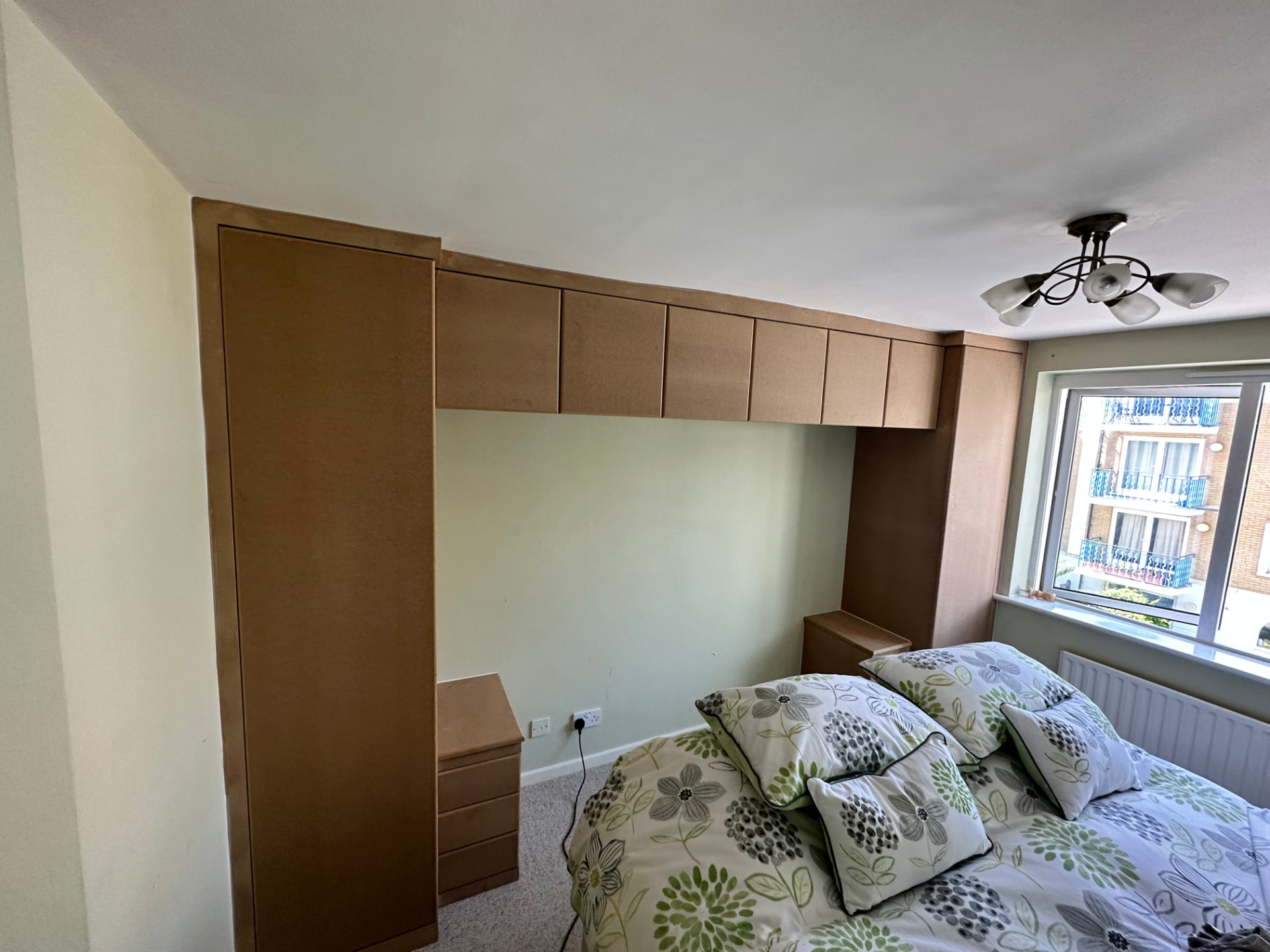 Over-bed storage bridge with top cupboards and matching bedside units
